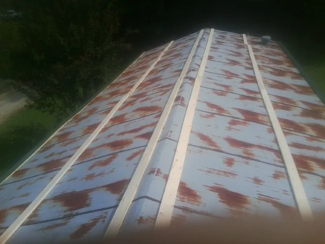 Rusted metal roof panels with new wood purlins before replacement — Storm Damage Roof Repair in Stratton by Roofing Brothers