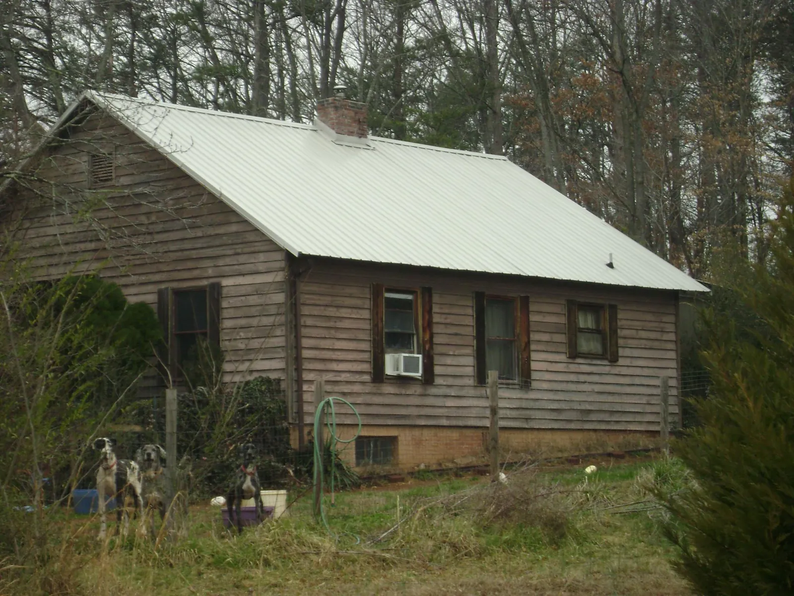 White metal roof on an old wood sided farmhouse, from a Metal Roof Installation job in Stratton